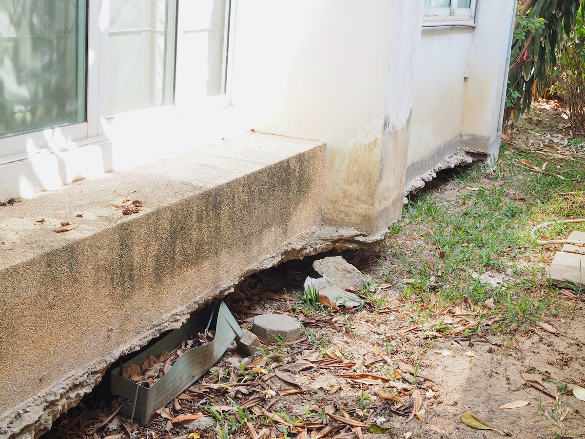 A home with damaged foundation due to subsidence or sinking land below the foundation.