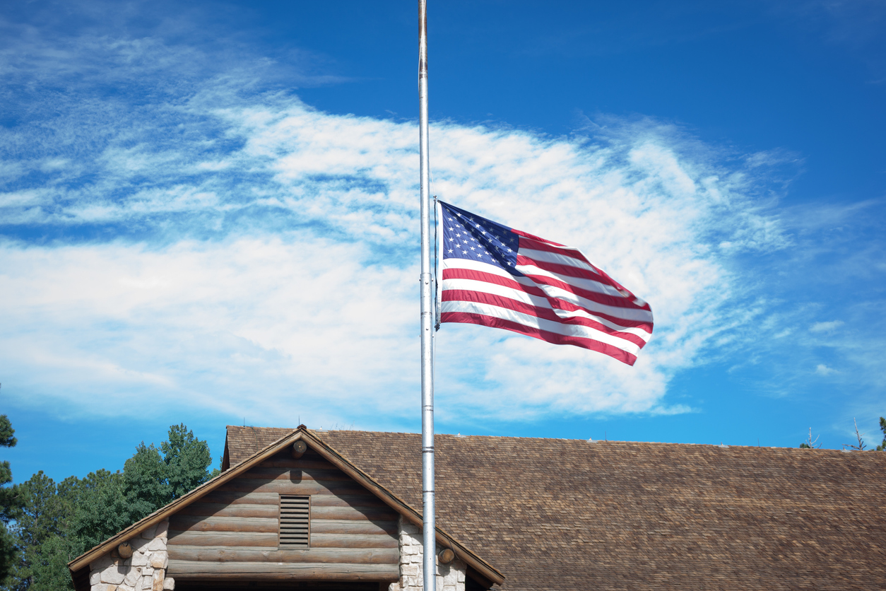 American flag flying at half staff