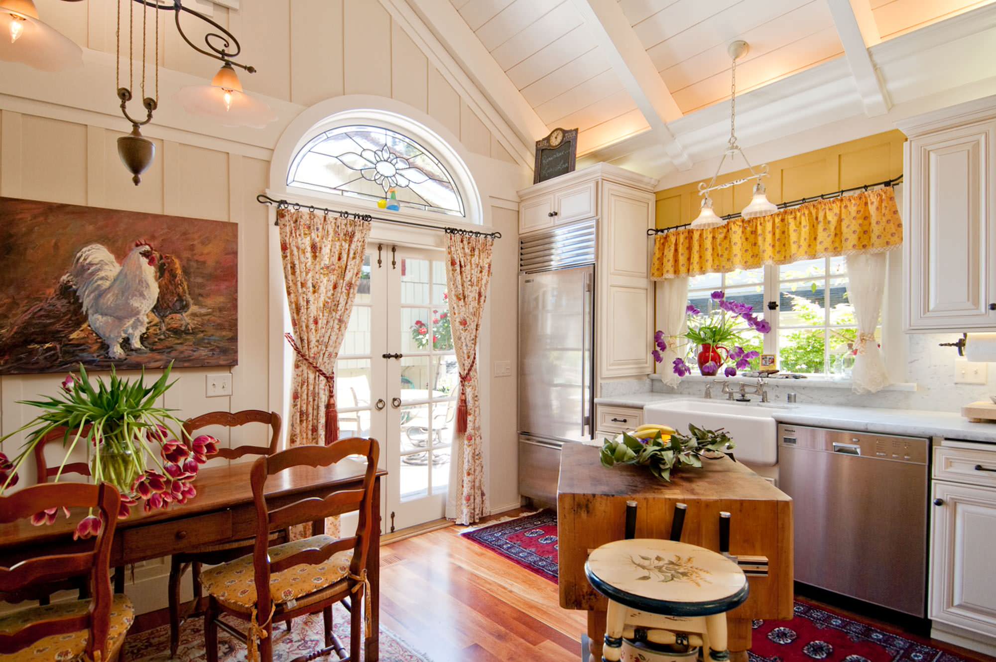 A country style kitchen with patterned curtains.