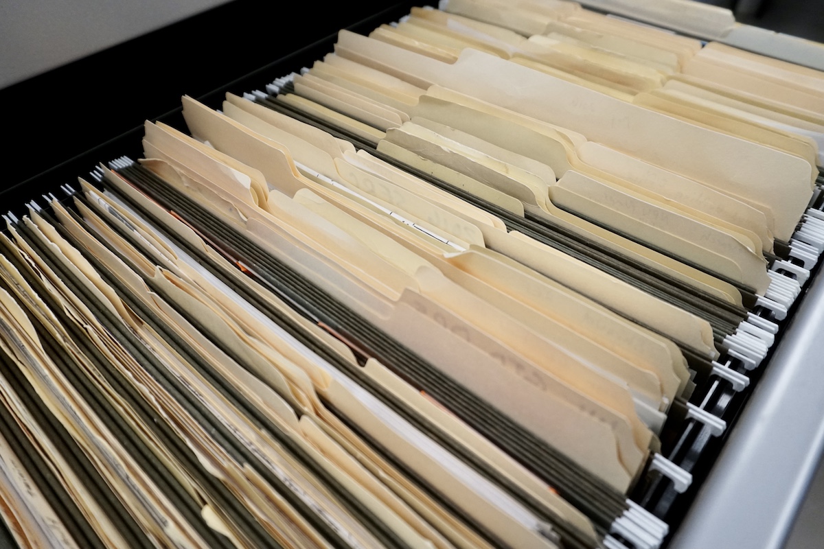 Dozens of manila folders in a file cabinet.