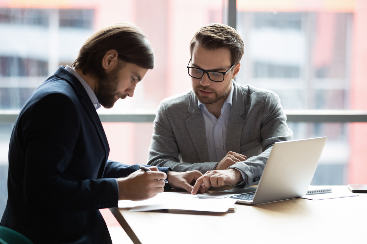 lawyer helping a man review a contract