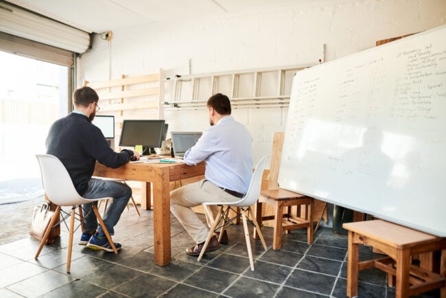 Two men working in home office/converted garage