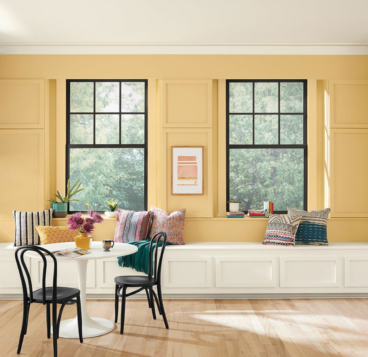 Kitchen sitting area with yellow walls.