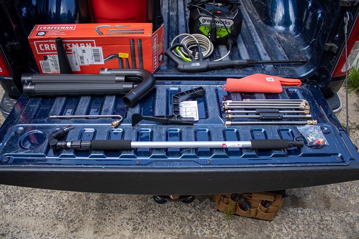 Multiple gutter cleaners lined out on the back of a pickup truck