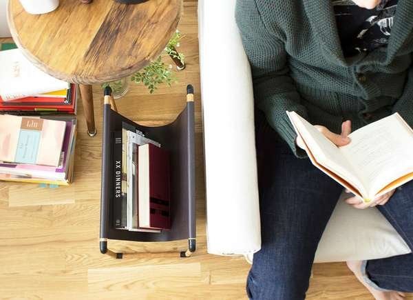 Overhead shot of a magazine rack and someone reading on the couch