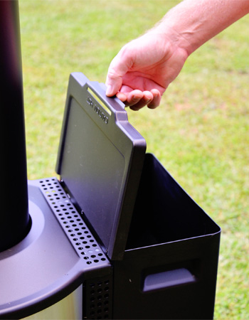 Person opening the hopper lid of a Solo Stove Tower Patio Heater.