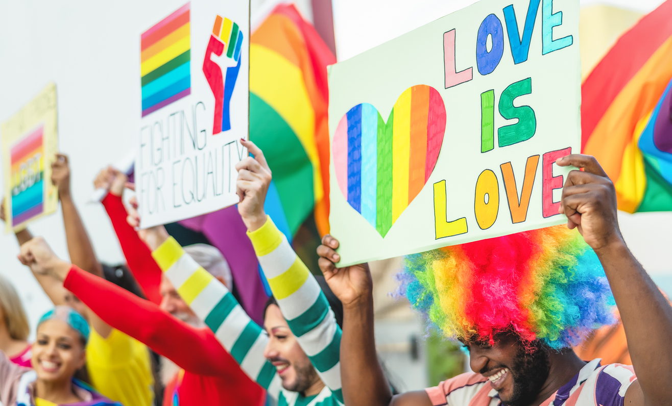 Happy Multiracial people celebrating gay pride event - Group of friends with different age and race having fun during LGBT social event