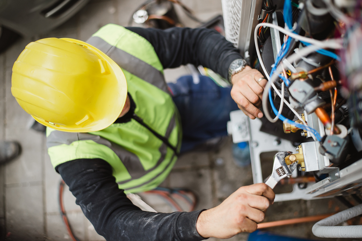 iStock-1291724300 standby generator Air conditioner technician services outdoor AC unit and the Gas Generator