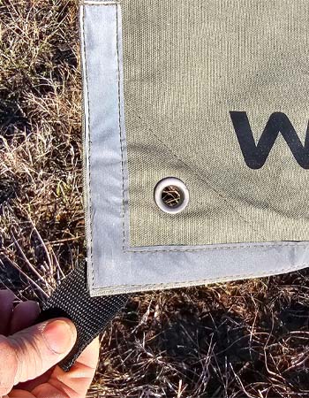 The reinforced grommets at the corner of the White Duck tarp.