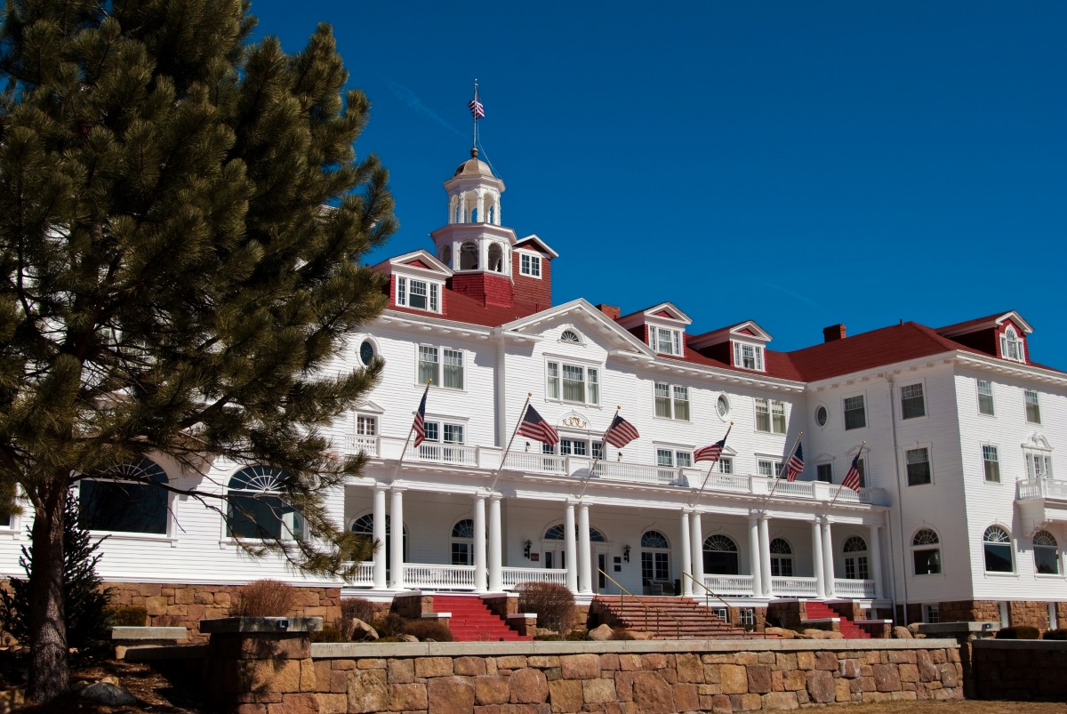 Large white hotel with red roof