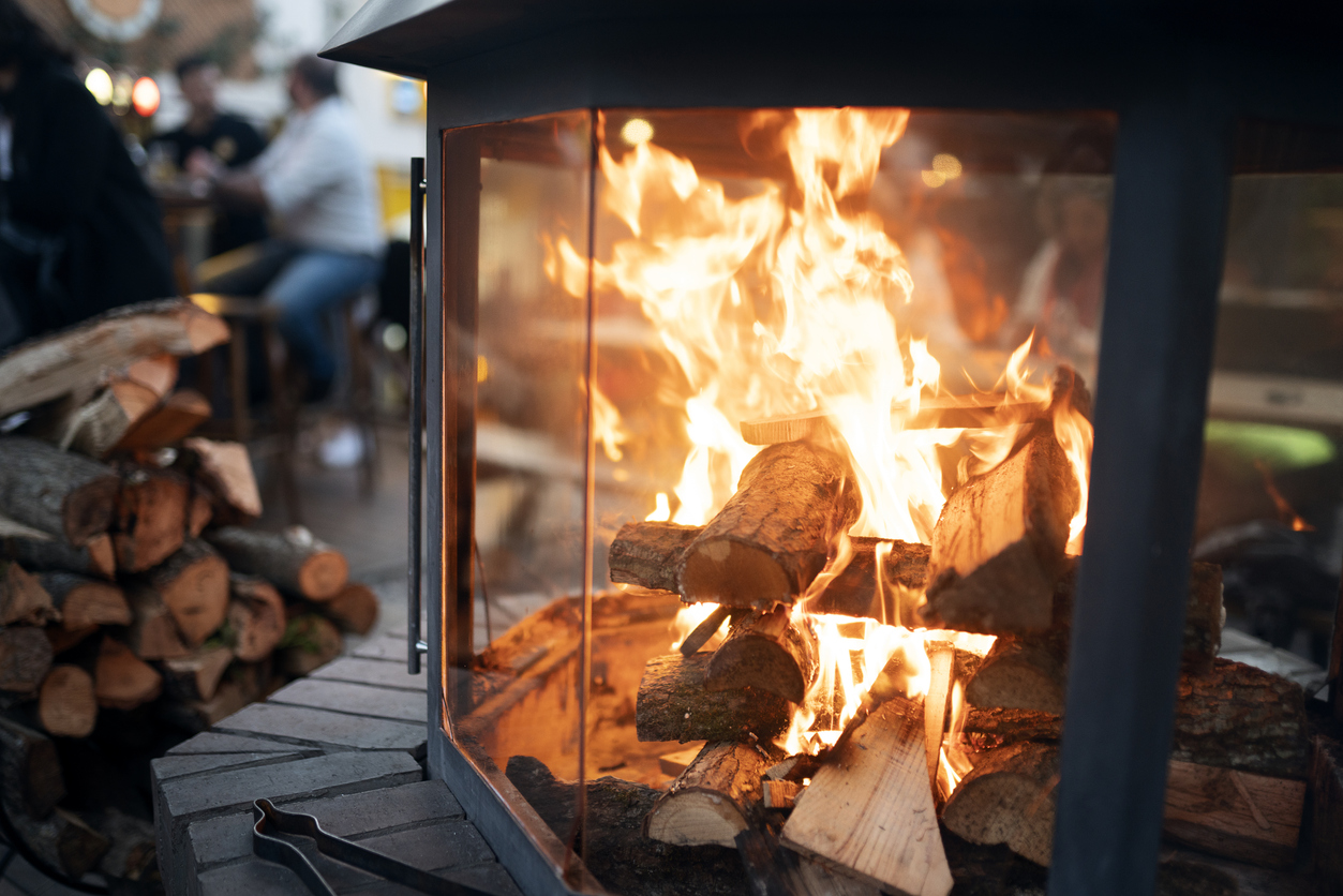 how to clean a fireplace wood burning fireplace with bright flames stack of logs nearby