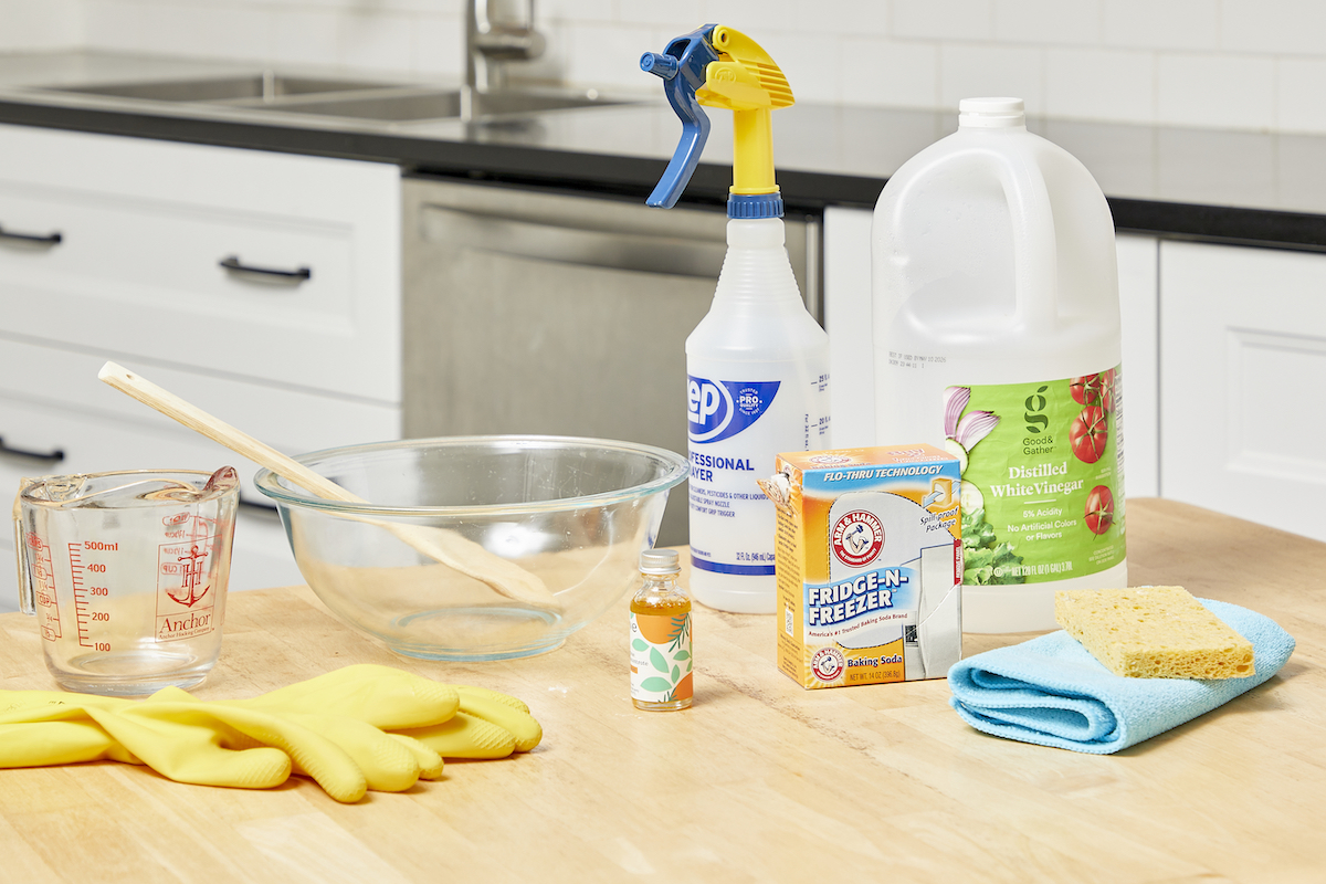 Materials needed to make a homemade oven cleaner spread on kitchen counter.