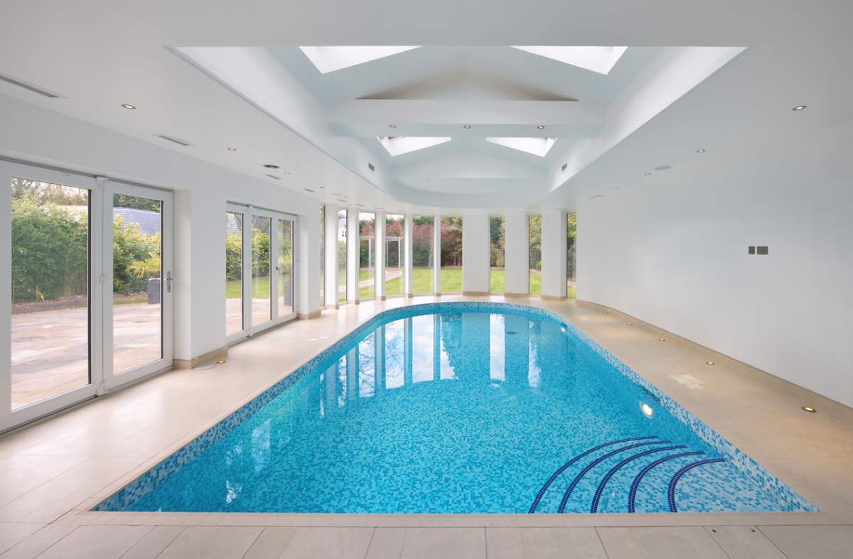 Indoor pool in white room.