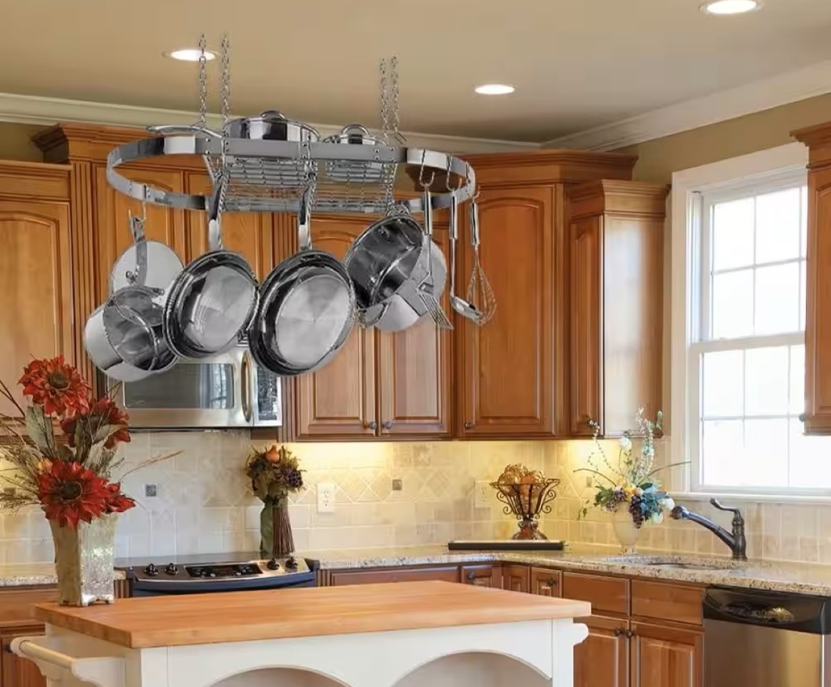 Kitchen with wooden cabinets and large overhead pot rack.