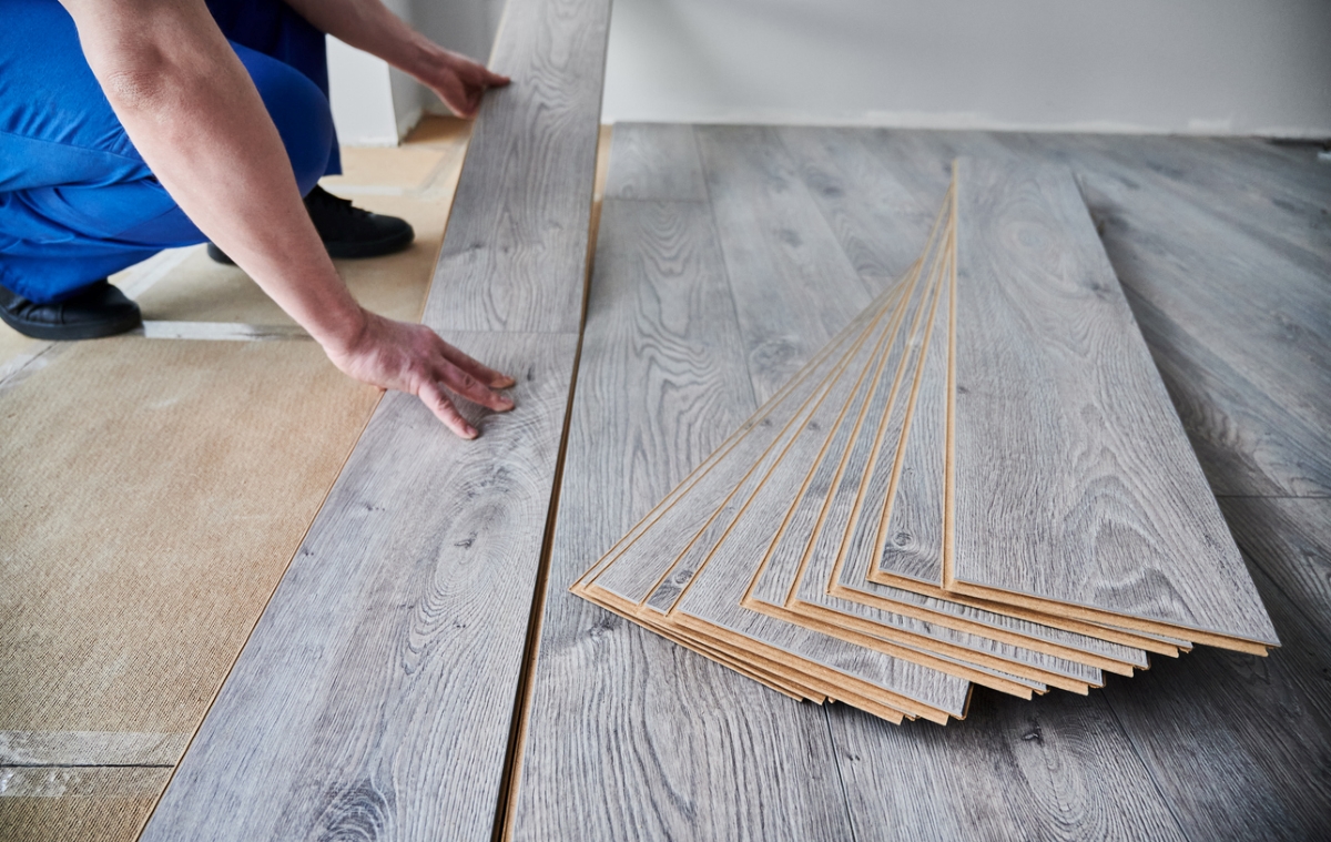 Person laying vinyl planks on floor