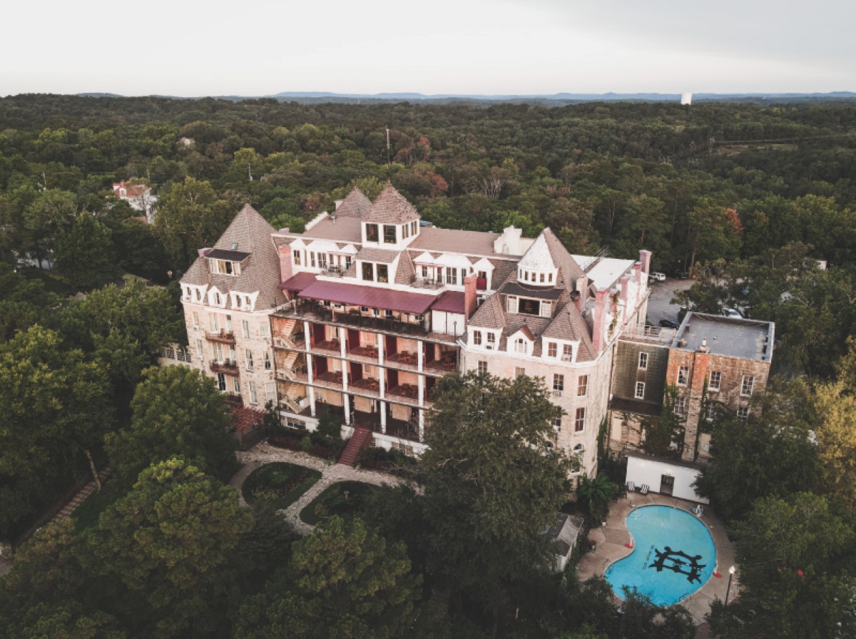 Aerial view of hotel surrounded by forest