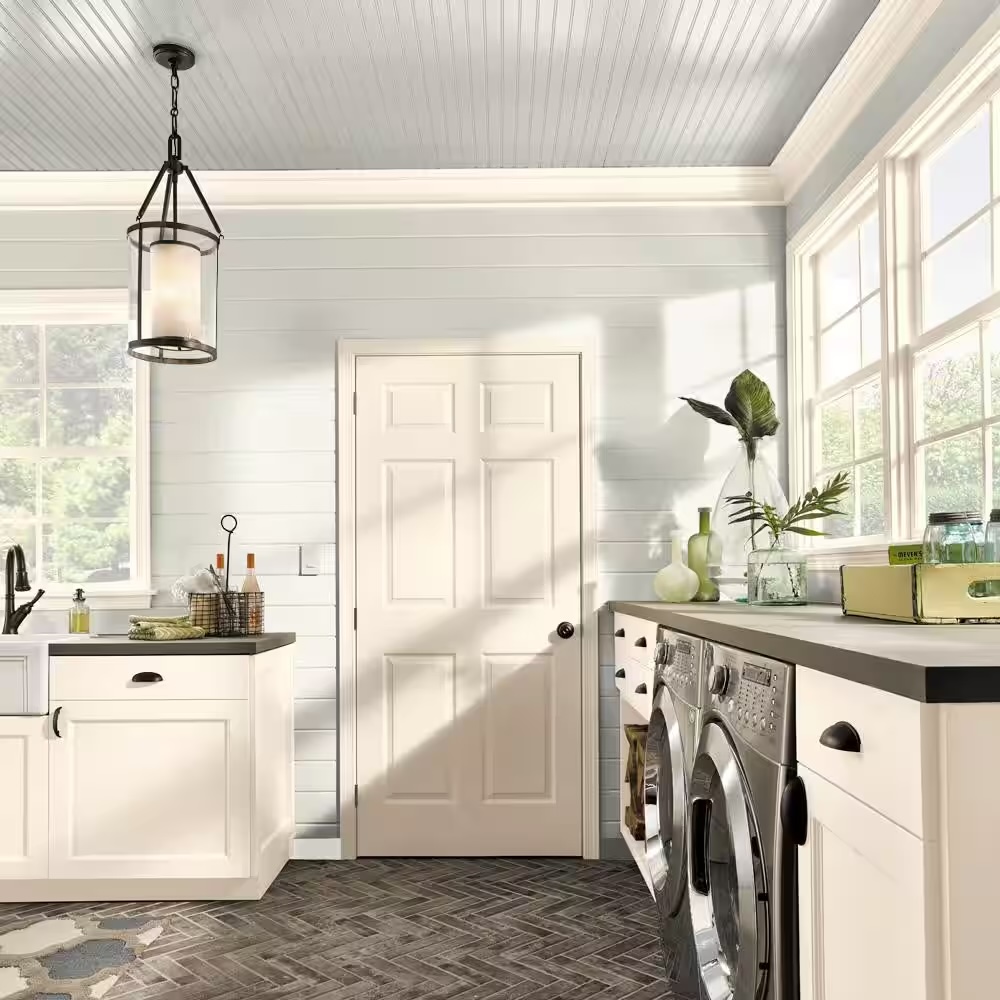 Modern and stylish laundry room painted in Swiss Coffee by Behr.