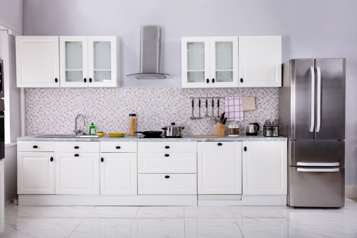 Kitchen with large area above top cabinets cleared.