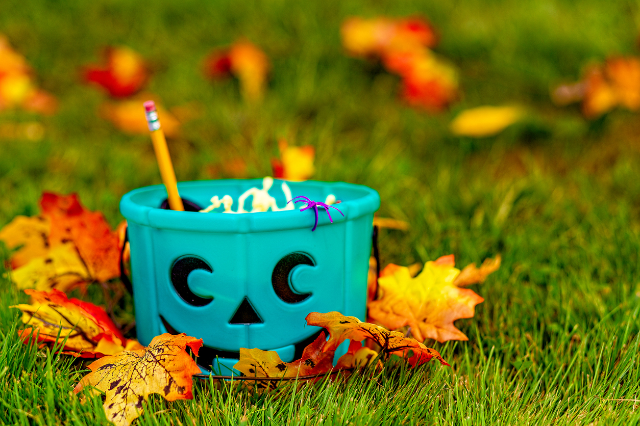 Teal pumpkin candy bucket full of non-food Halloween treats