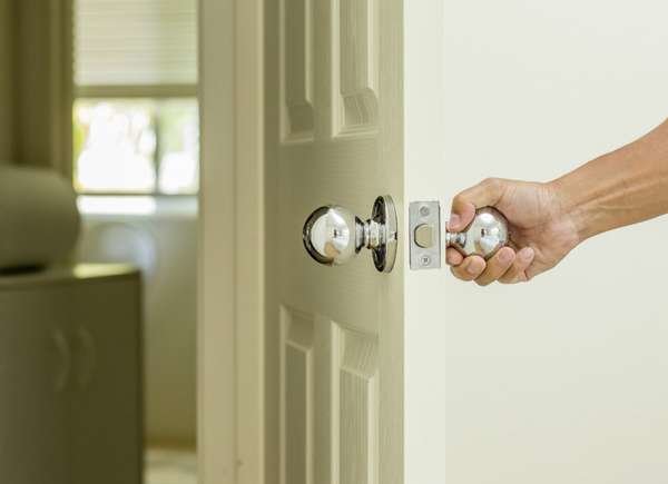 hand closing door in house