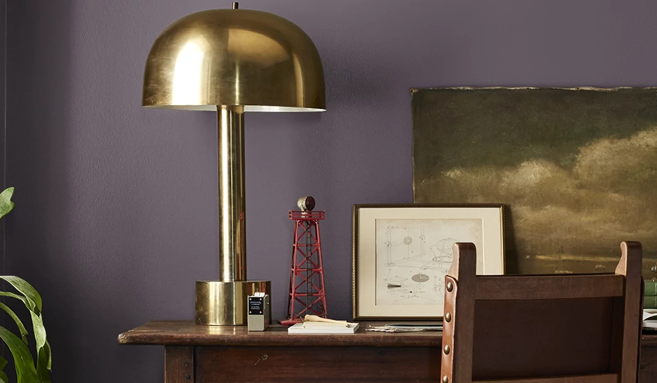 close view of desk with plum colored walls