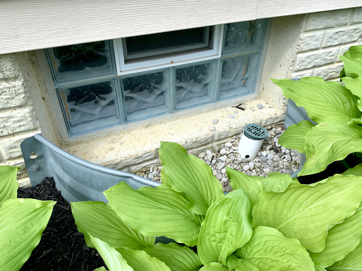 high angle view of exterior basement glass block window