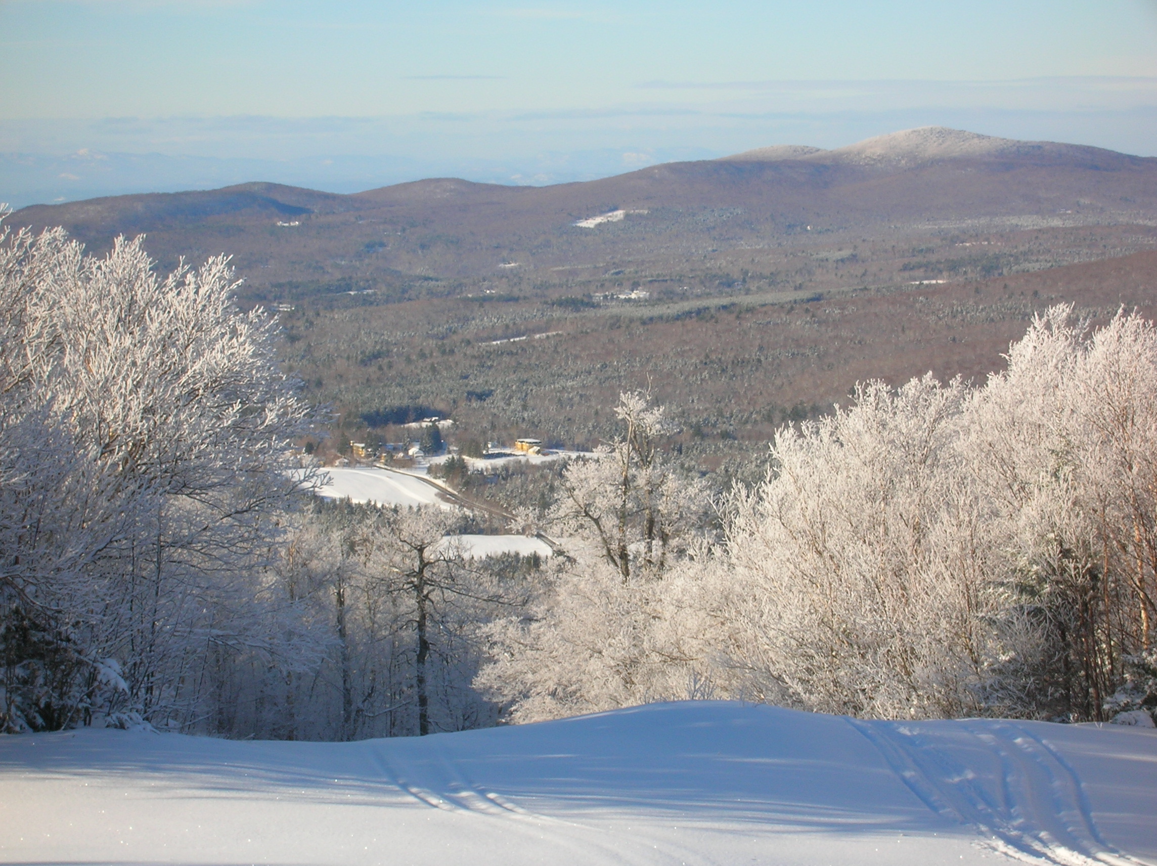 landscape view of hills and town covered in snow