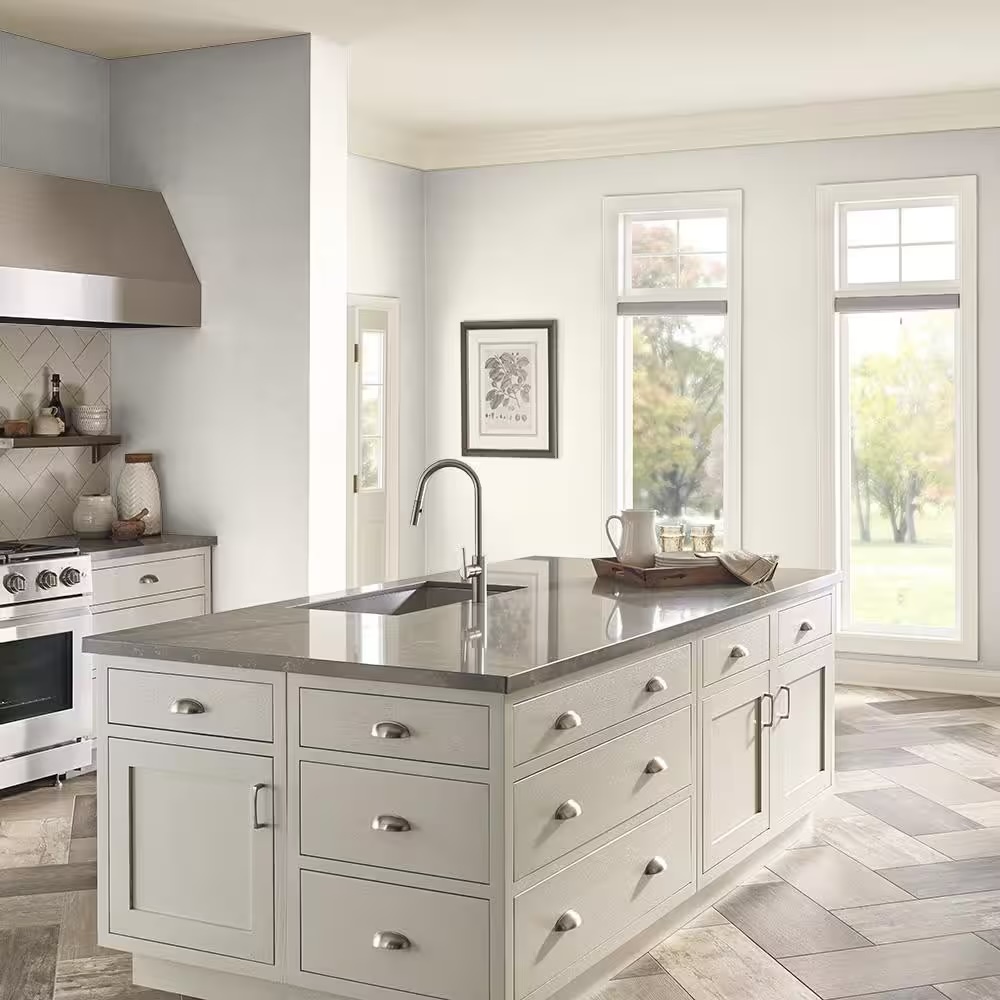 Modern kitchen with stainless steel appliances painted in White Veil by Behr.