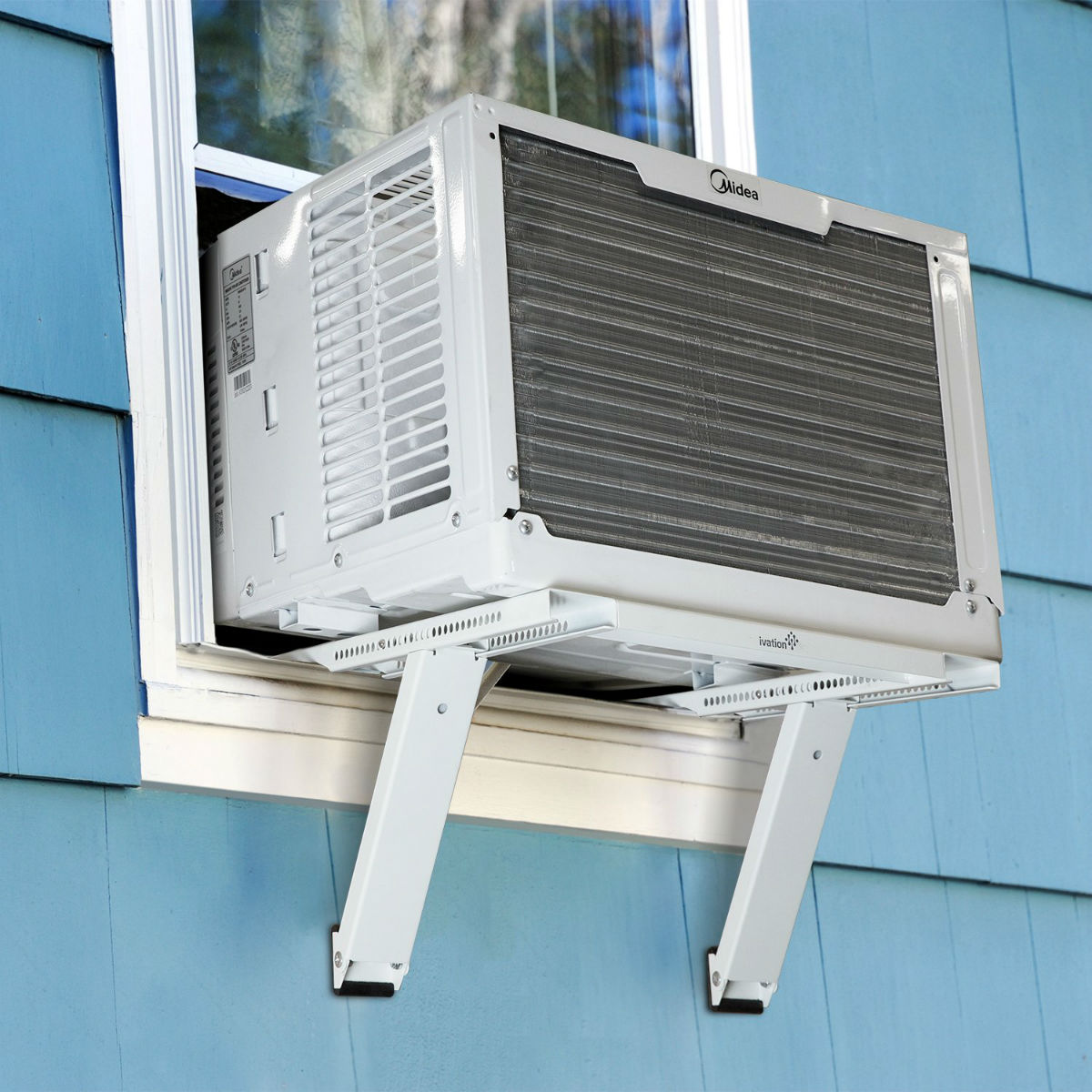 A window air conditioner unit is supported by brackets underneath it.