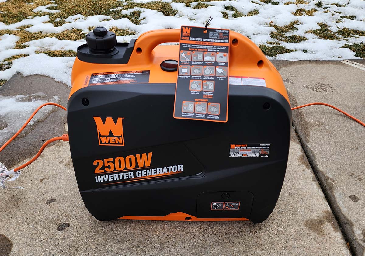 Wen DF250i 2500 watt Dual-fuel Inverter generator on concrete in front of snow