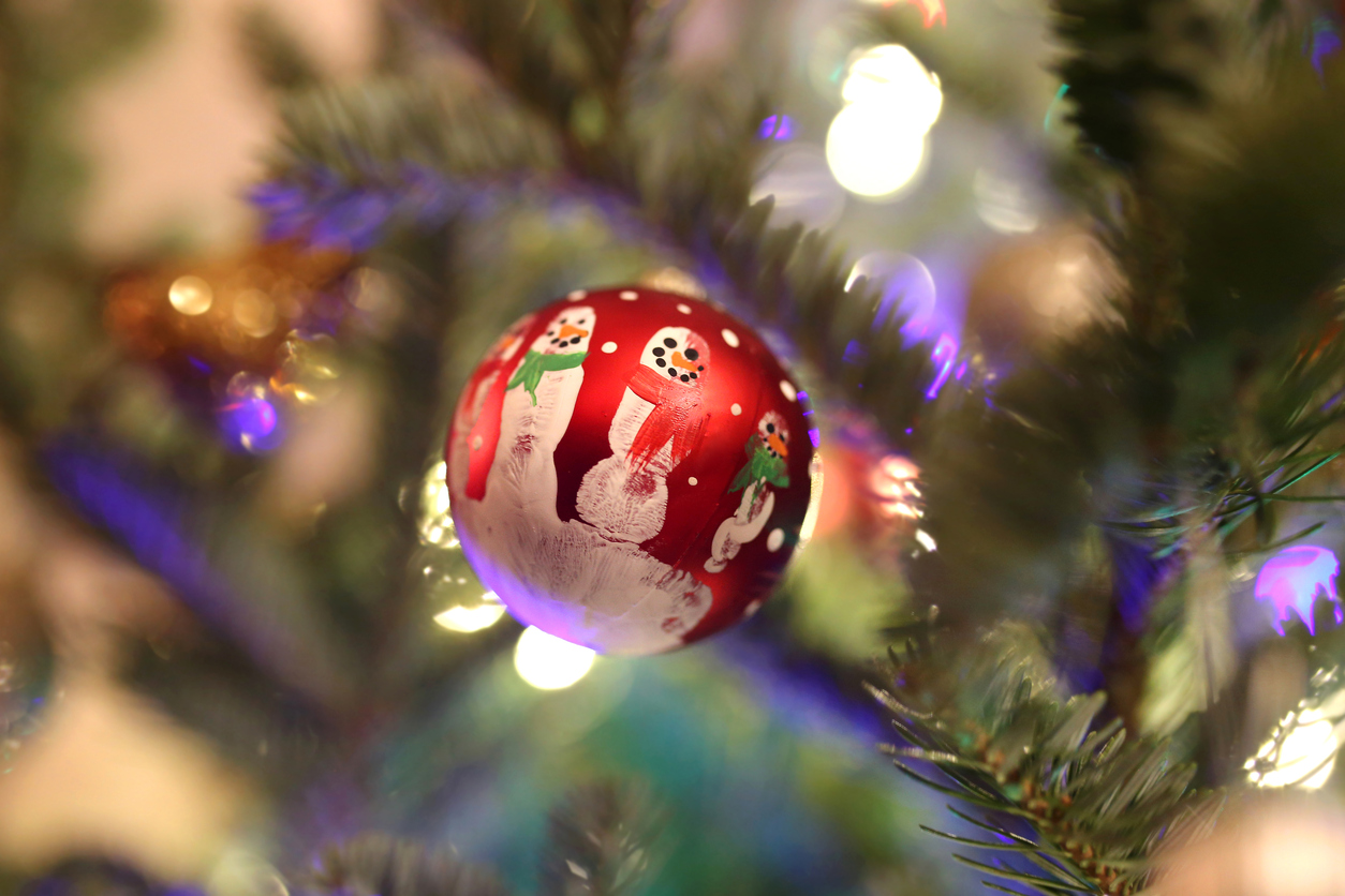 A-red-Christmas-ornament-is-painted-with-snowmen.