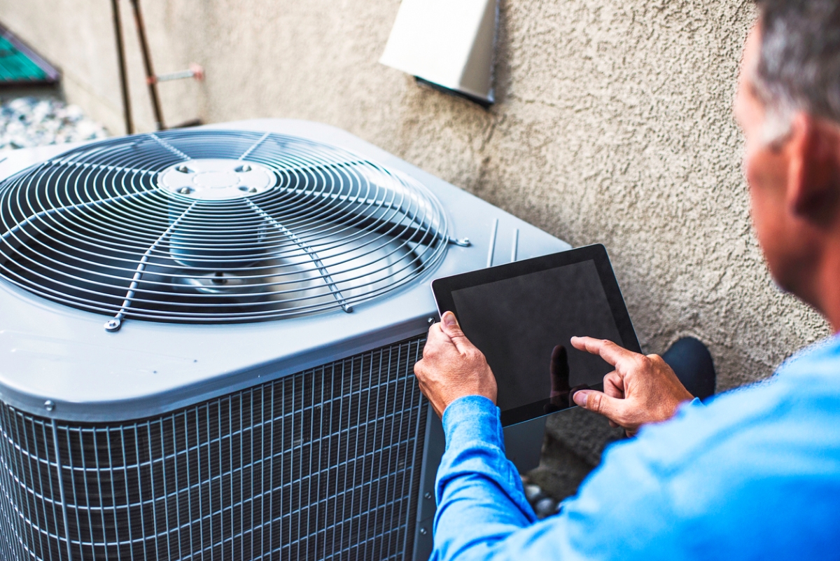 Person using tablet to check hvac