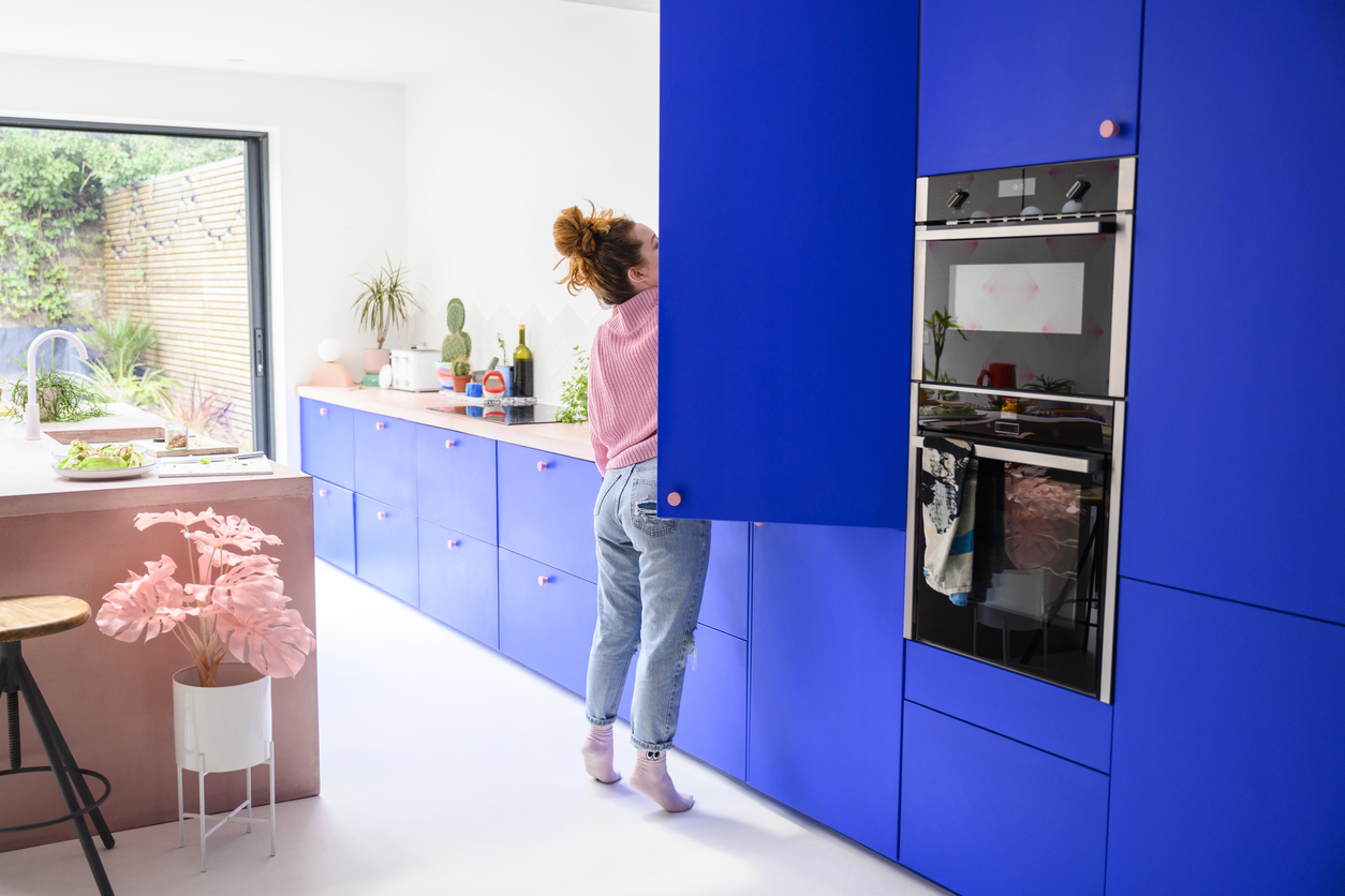 iStock-1319473977 disguise appliances Mid adult Caucasian woman reaching into refrigerator