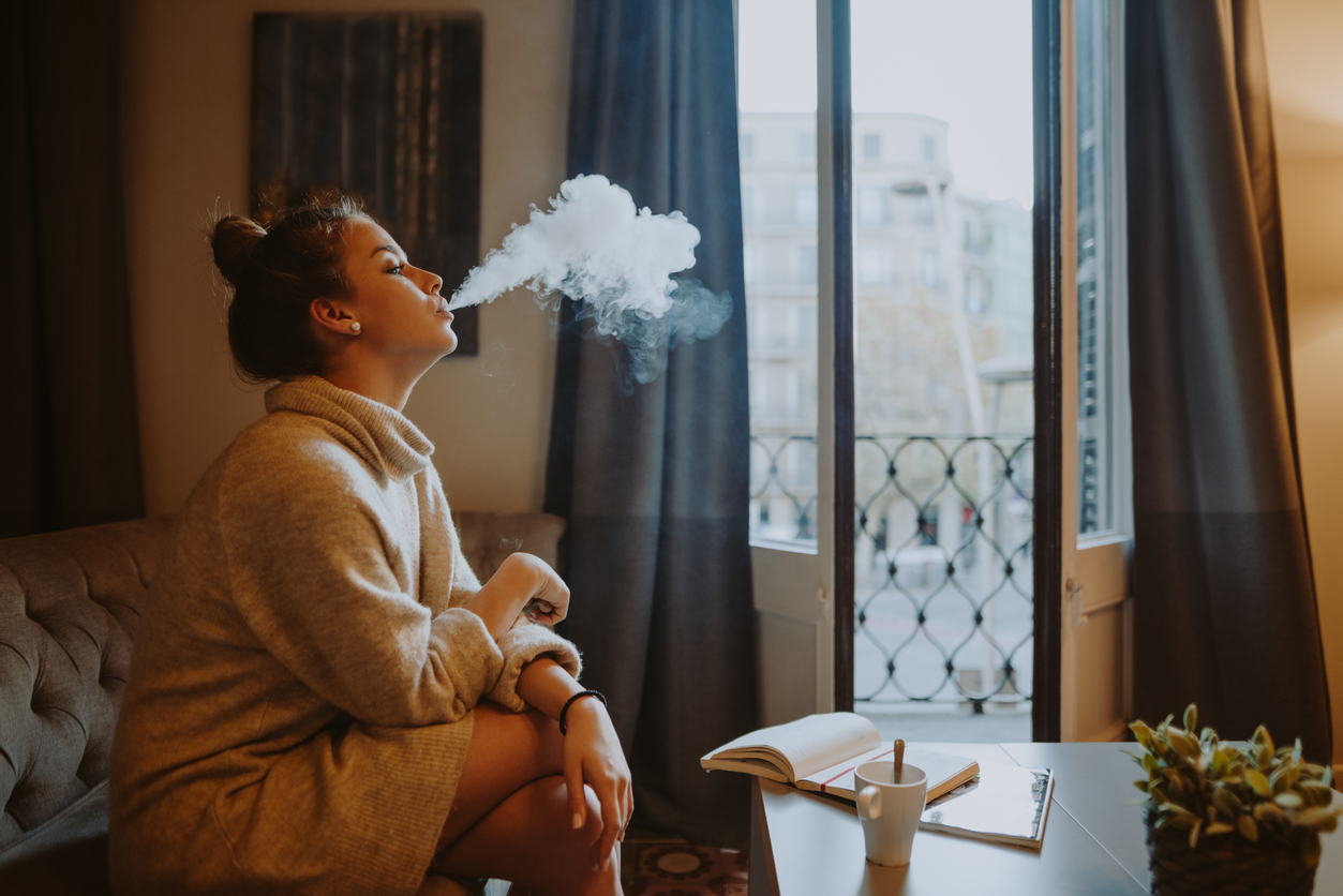 iStock-1018792606 get the funk out of curtains and rugs woman smoking in living room.jpg