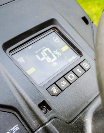 Ryobi lawn tractor's LCD monitor displaying runtime, battery level, and charge status