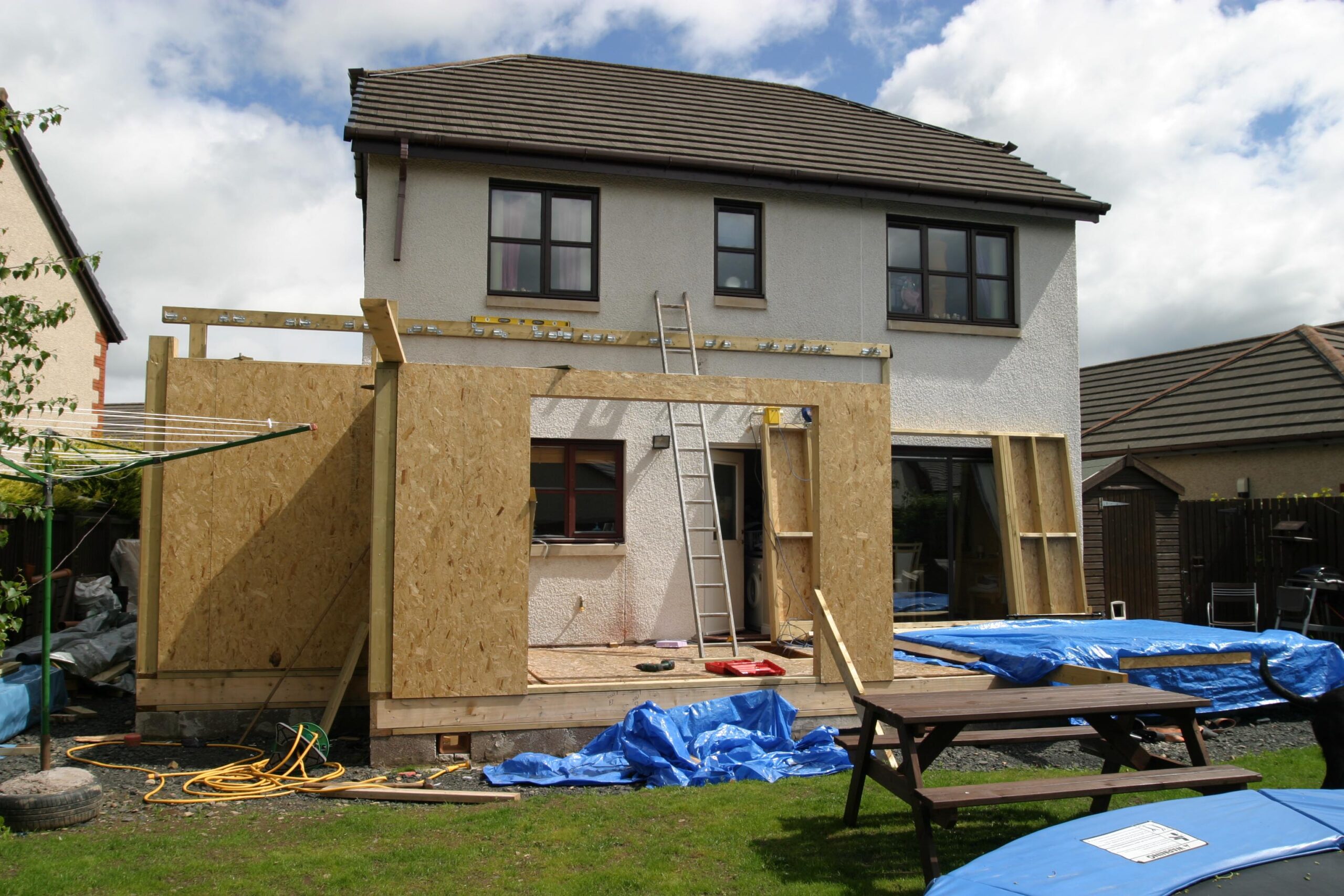 An addition is being built onto the back of a two-story home.