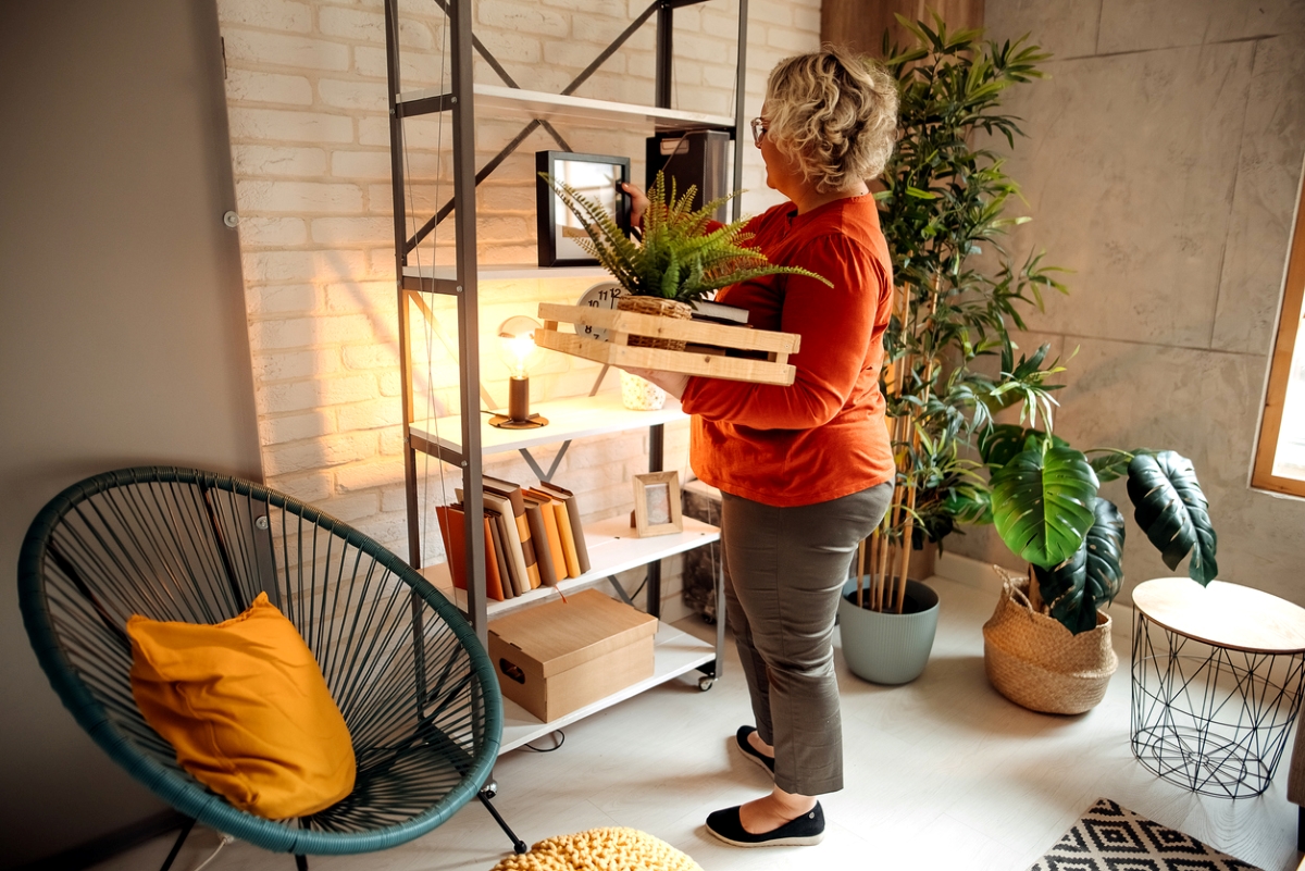 how to declutter your home - woman organizing shelf