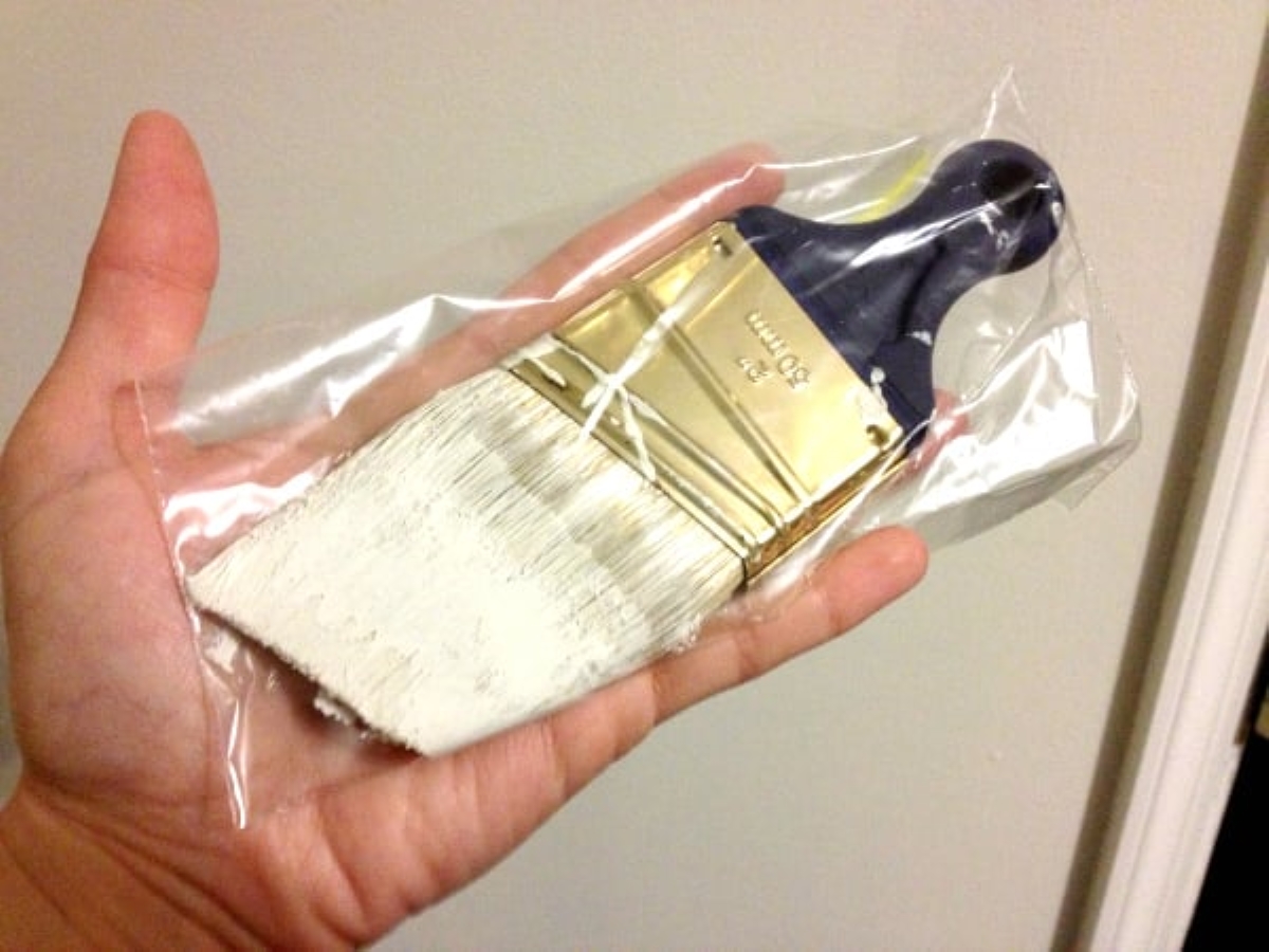 Wet paint brush in plastic bag.