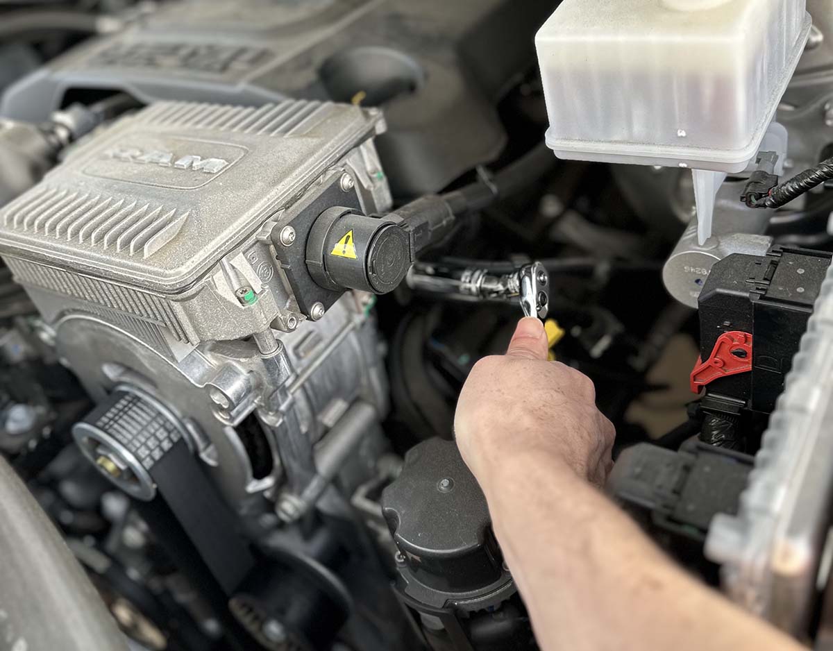 A person working on an engine using the DeWalt mechanics tool set