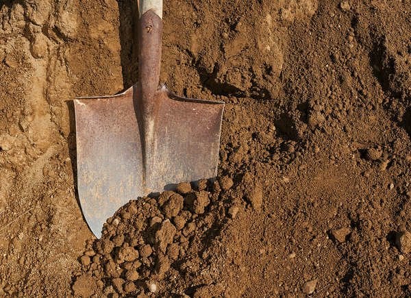 Overhead shot of shovel over pile of dirt