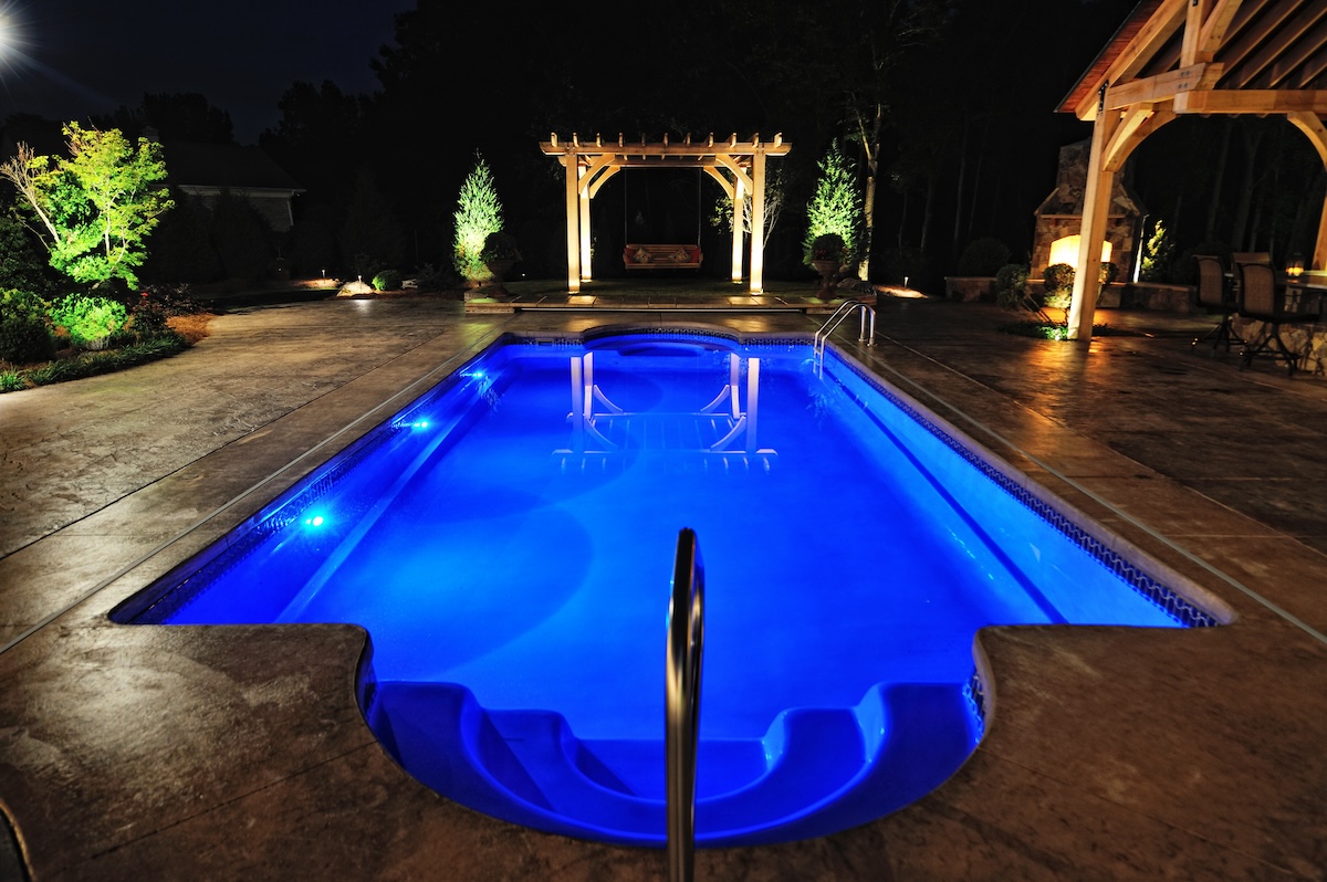 Swimming pool with blue interior and lights for night swimming.