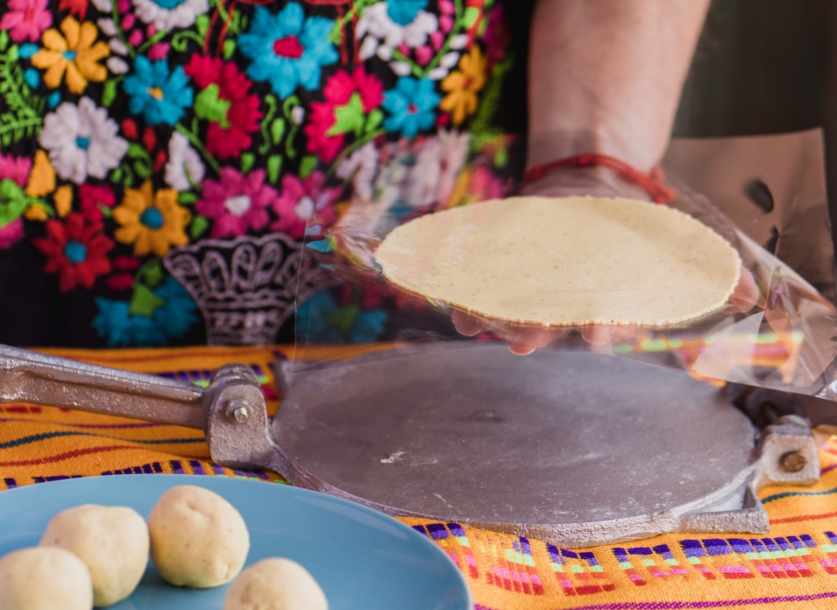 Homemade tortilla with cast iron press.