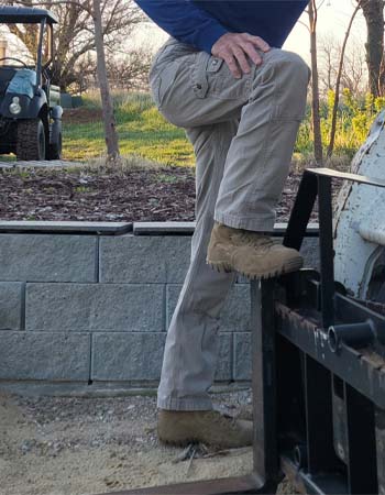 Man in Carhartt Cargo Pants stepping up on metal rails