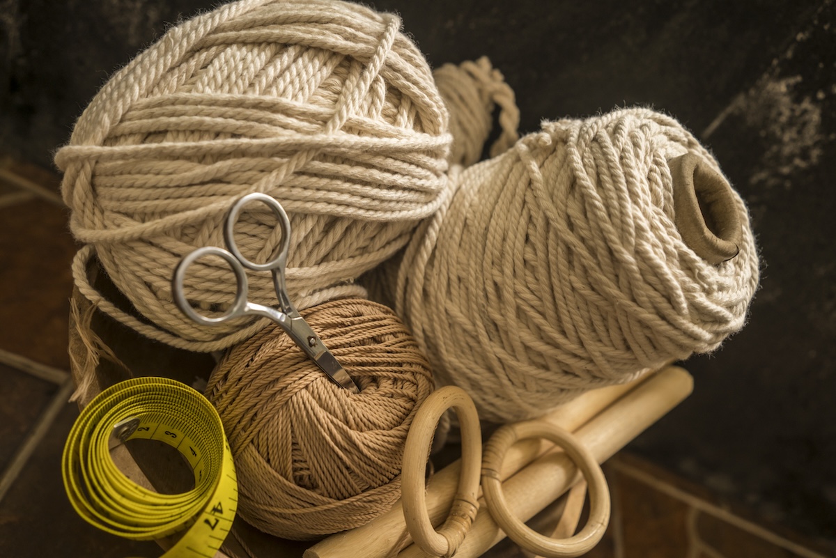 A group of macrame supplies on a table.