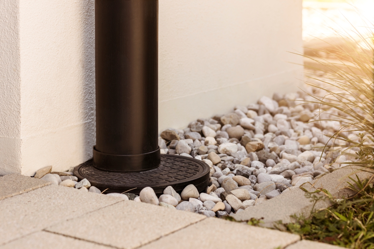 Water drainage pipe installed to lead water directly into French drain.