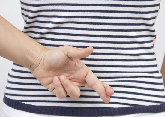 Woman crossing fingers behind her back