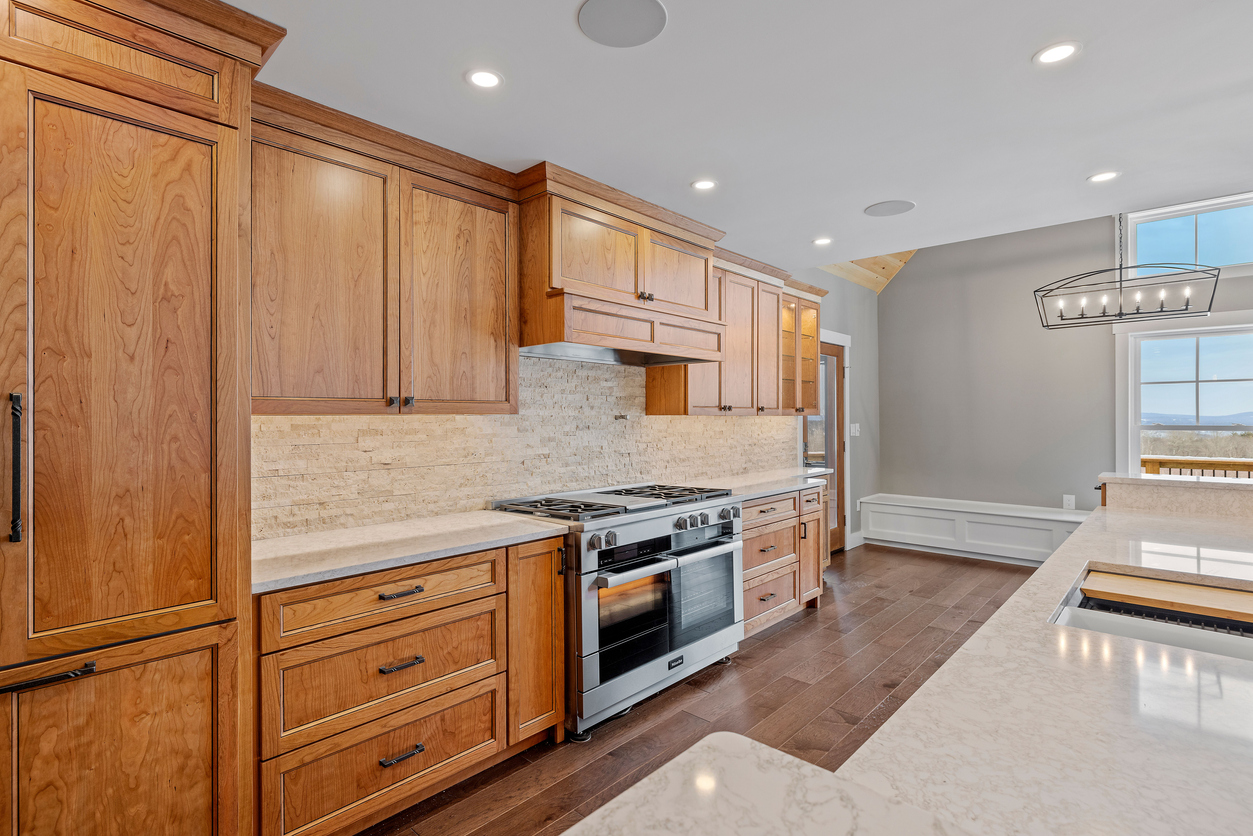 Tan wooden cabinets in modern kitchen.