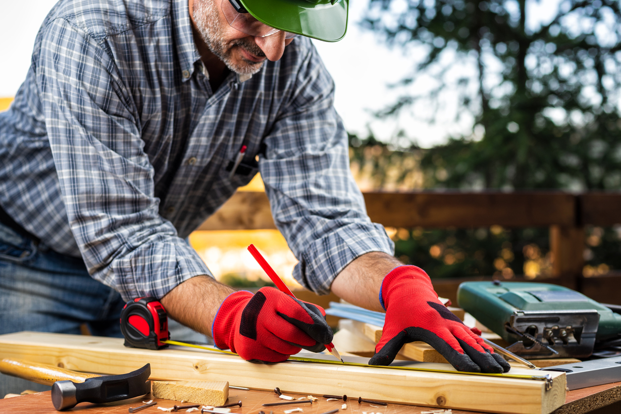 iStock-1184237494 volunteer opportunities man building wooden fence outside