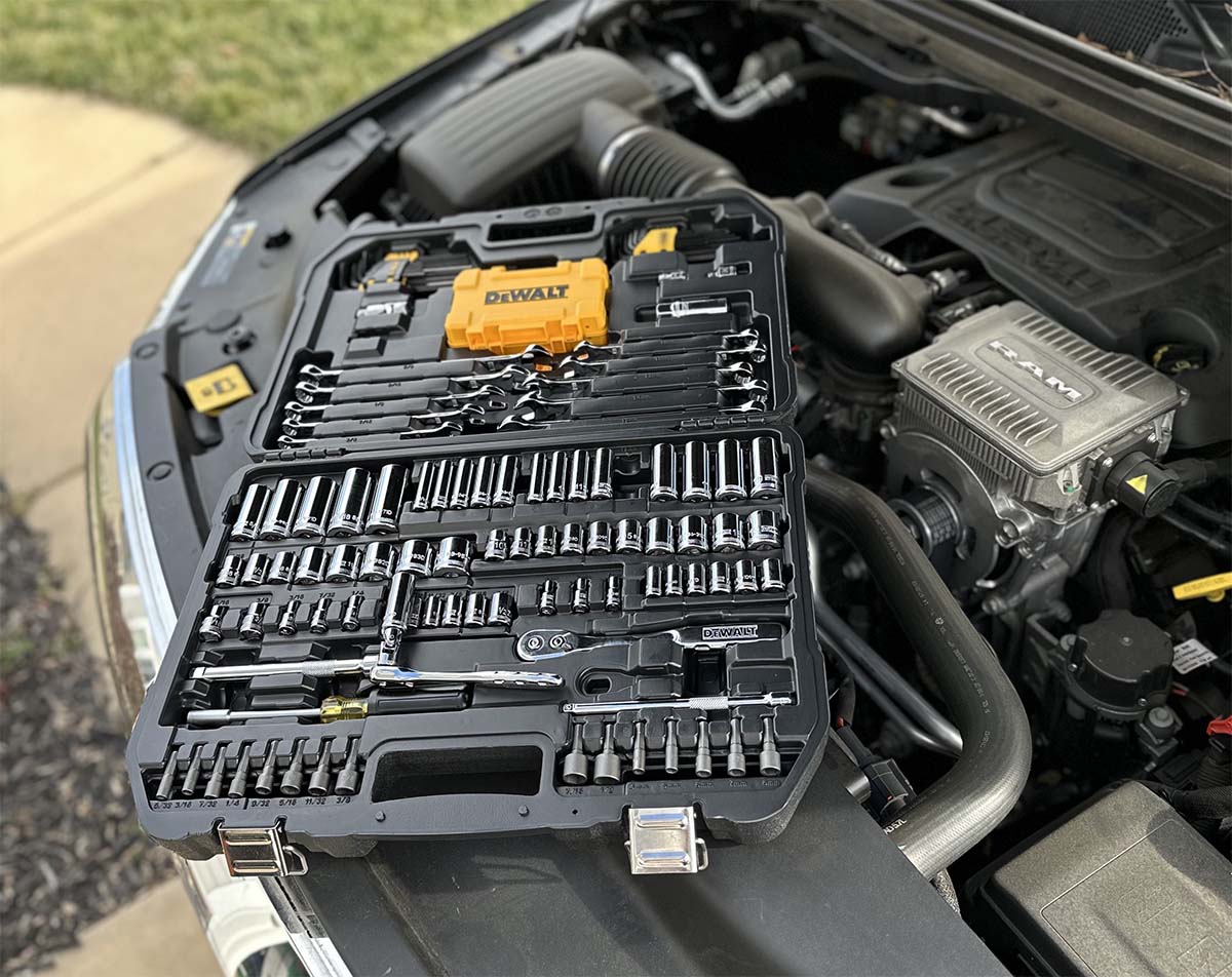 The DeWalt mechanics tool set open atop a car engine