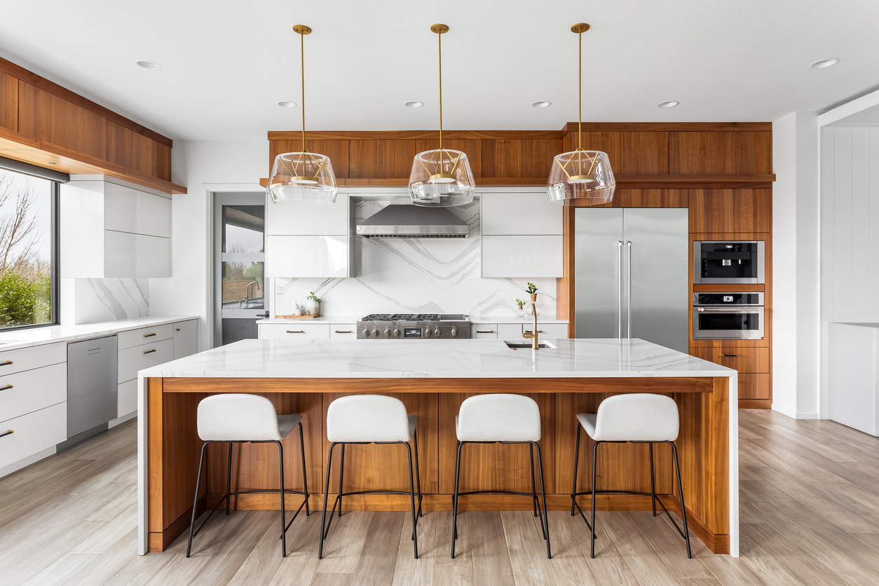 Sleek and modern kitchen with natural hardwood cabinets. .